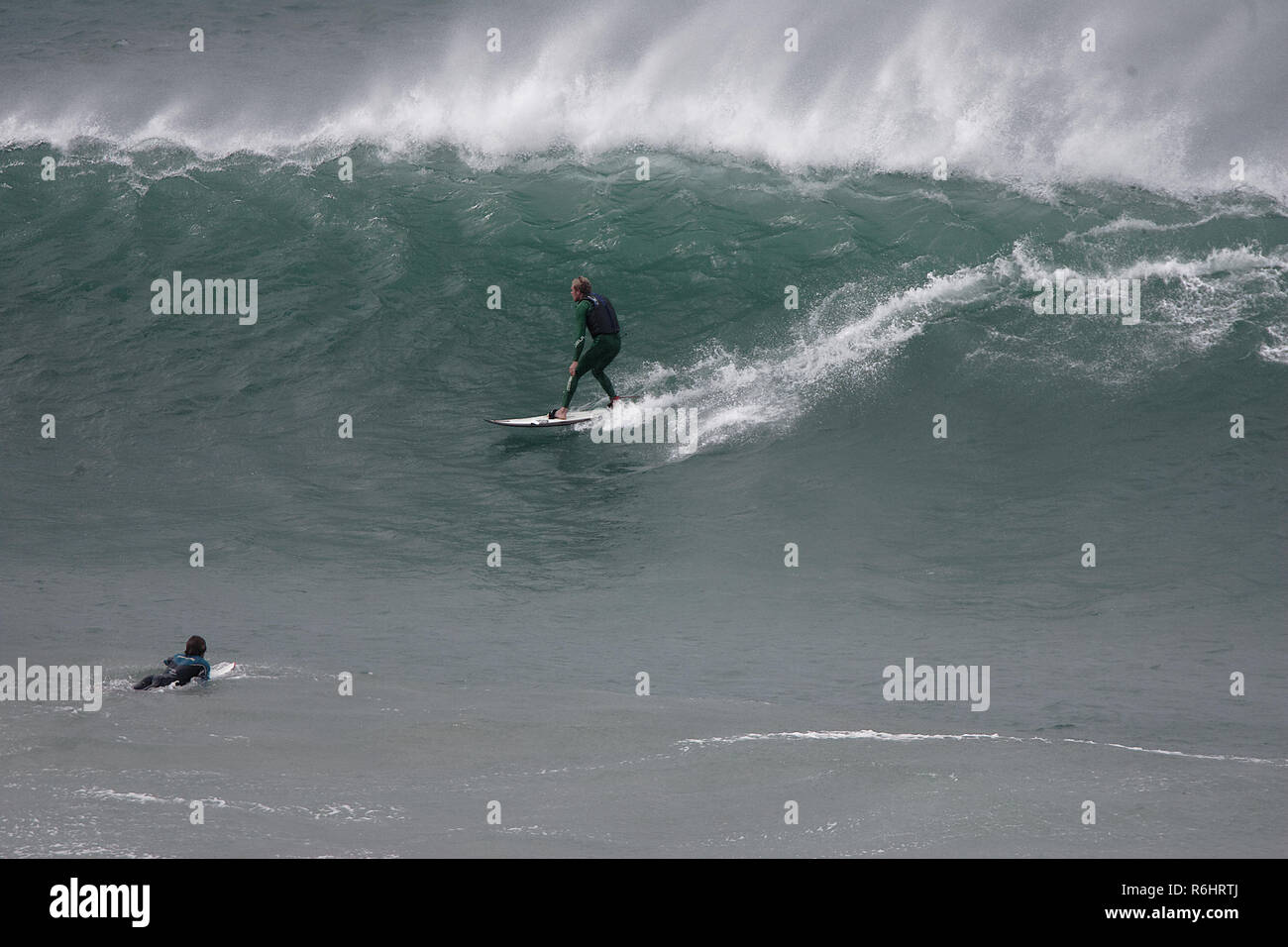 Big wave surfing at Newquay`s Cribbar point at Fistral Bay, Cornwall, UK Stock Photo